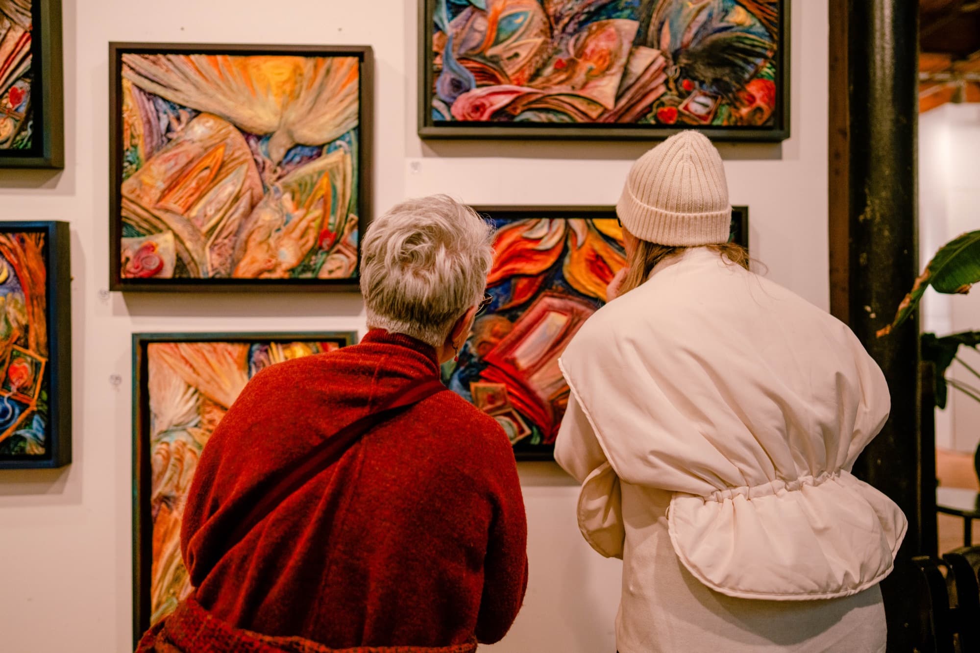 Visitors with Jonathan's framed carvings at The Figure Within opening, Chicago studio